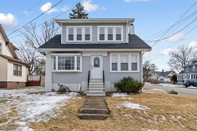 bungalow-style home featuring a shingled roof and entry steps