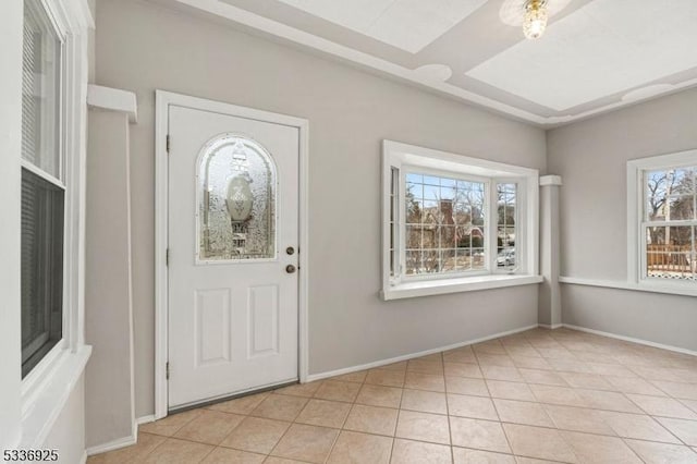 foyer entrance featuring baseboards and light tile patterned floors