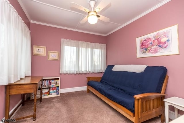 sitting room with carpet floors, ornamental molding, and ceiling fan