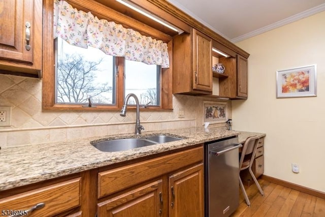 kitchen featuring sink, crown molding, light stone counters, dishwasher, and backsplash