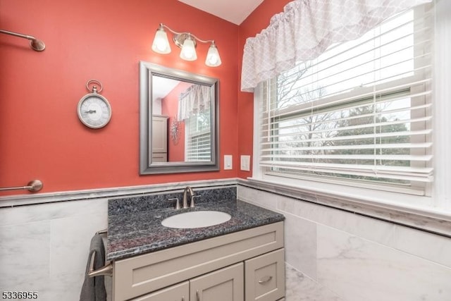 bathroom featuring vanity and tile walls