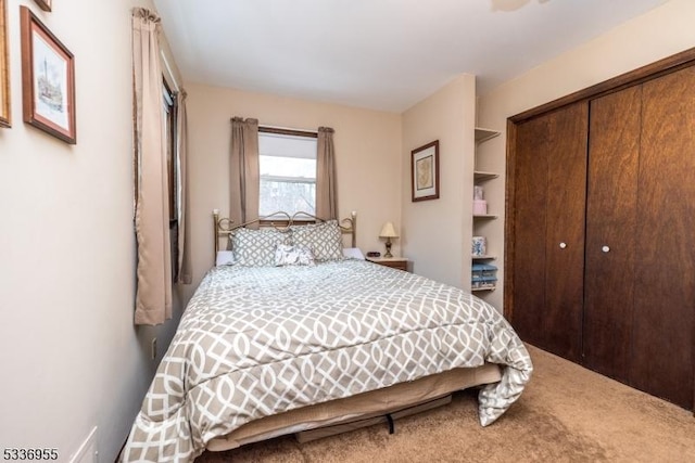 carpeted bedroom featuring a closet