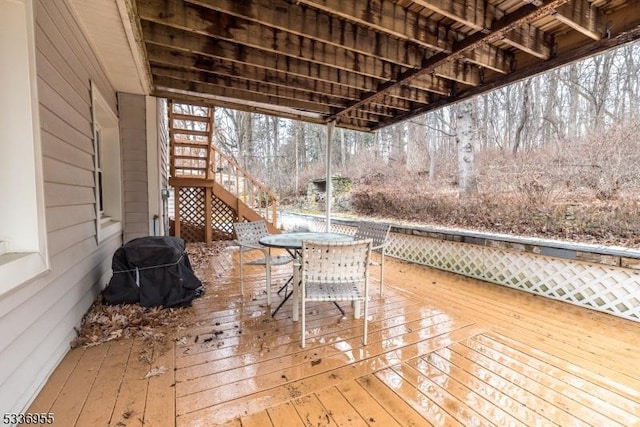 wooden deck with a grill