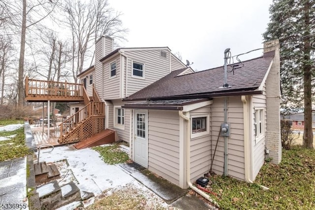 rear view of property featuring a deck