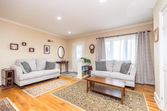 living room with crown molding, a healthy amount of sunlight, and hardwood / wood-style flooring