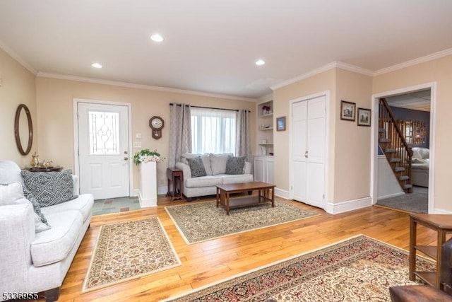 living room featuring hardwood / wood-style flooring and crown molding