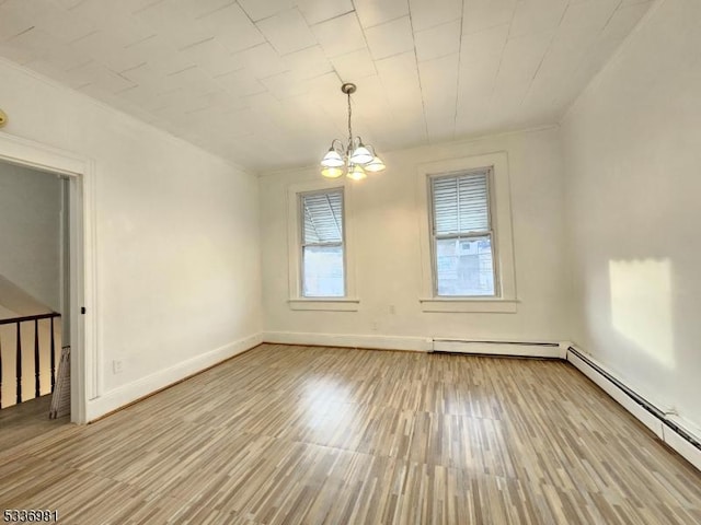 empty room featuring a baseboard radiator, a notable chandelier, and light hardwood / wood-style floors