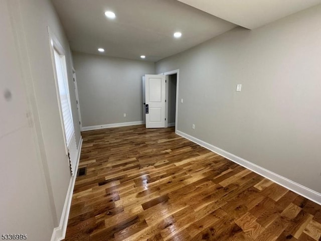 empty room with dark wood-type flooring