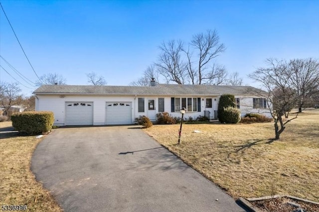 ranch-style home with a garage and a front yard