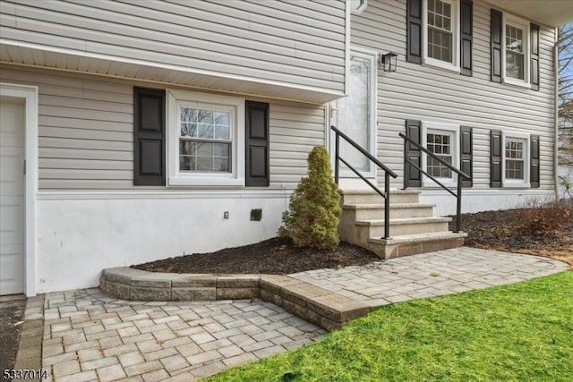 entrance to property featuring a patio