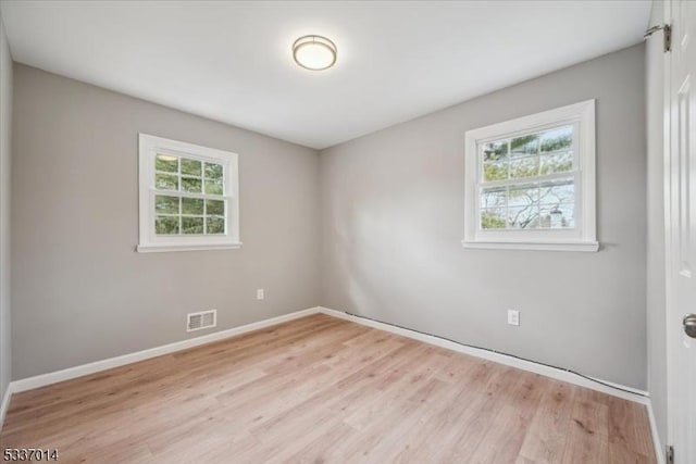 unfurnished room with light hardwood / wood-style flooring