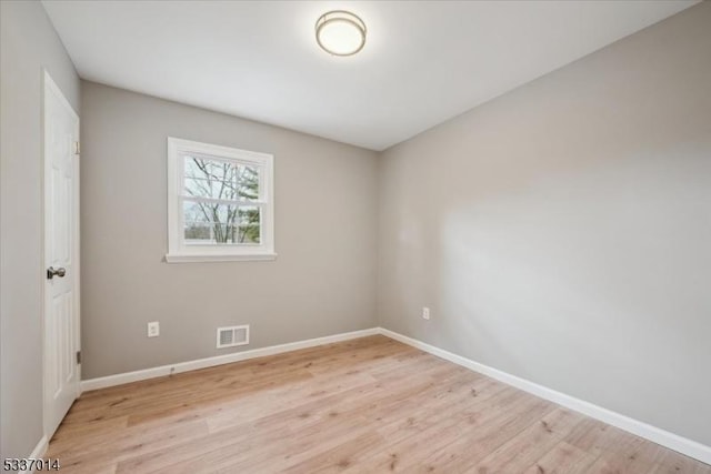 spare room featuring light hardwood / wood-style flooring