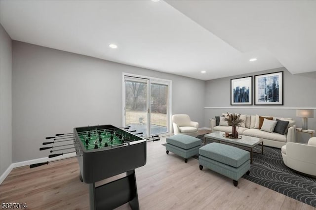 game room with light hardwood / wood-style flooring