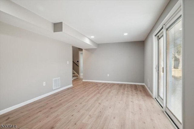 unfurnished room with light hardwood / wood-style floors