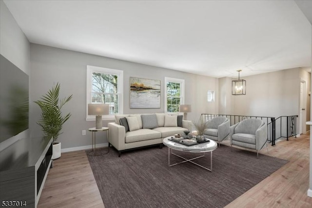 living room featuring a wealth of natural light and light hardwood / wood-style flooring