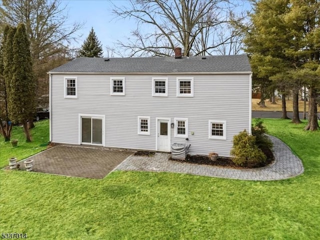 rear view of property featuring cooling unit, a yard, and a patio