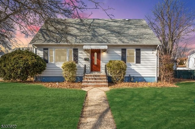 bungalow-style house featuring a yard