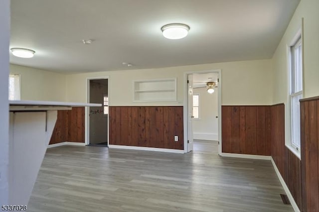 entrance foyer featuring hardwood / wood-style flooring and wood walls