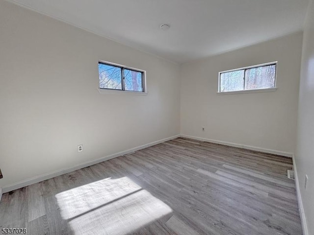 unfurnished room with light hardwood / wood-style flooring