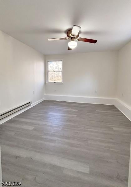 unfurnished room with dark hardwood / wood-style floors, ceiling fan, and baseboard heating