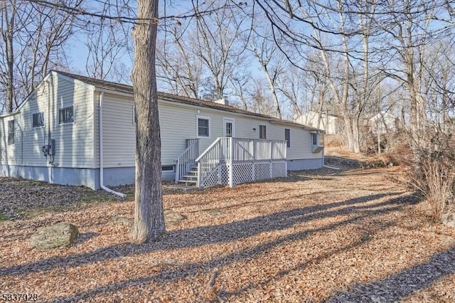 rear view of house with a wooden deck