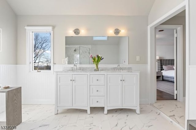 bathroom featuring vanity and a shower with shower door