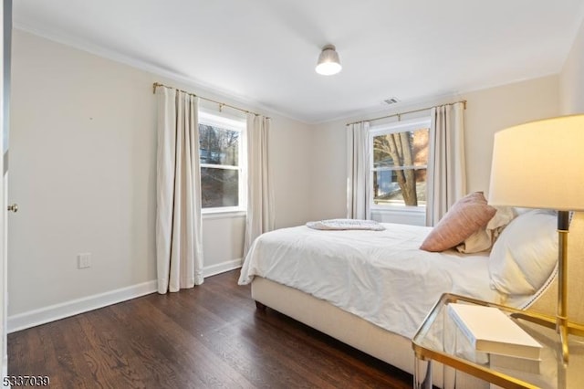 bedroom with dark hardwood / wood-style flooring