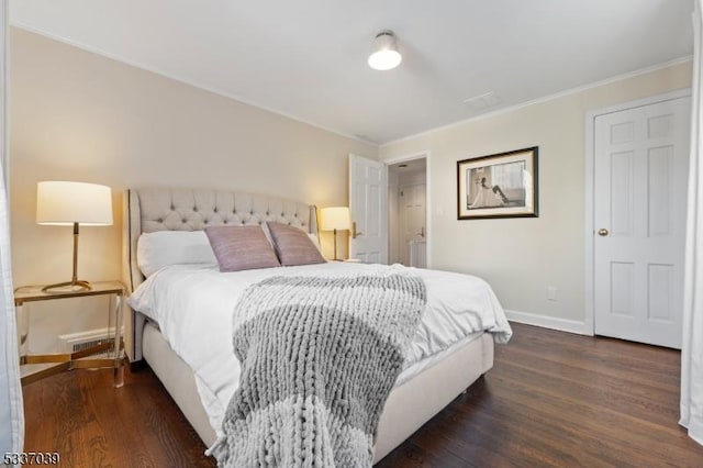 bedroom with ornamental molding and dark wood-type flooring