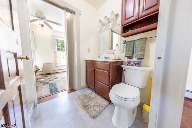 bathroom with vanity, toilet, and a ceiling fan