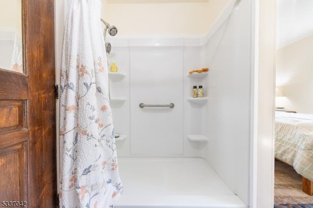 bathroom with a shower with curtain and ensuite bath