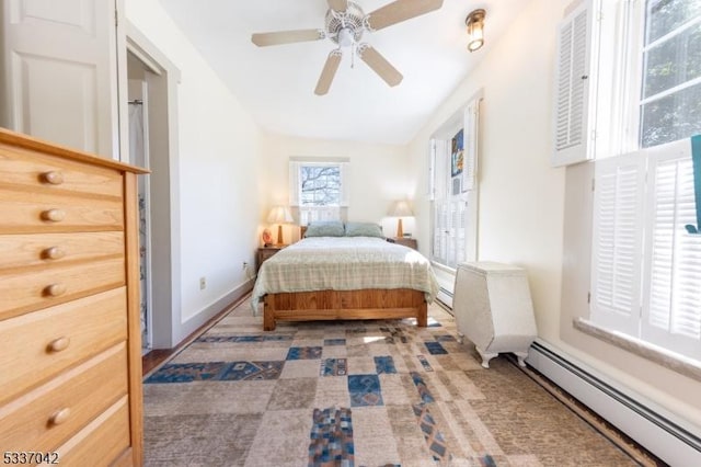 bedroom with ceiling fan, baseboards, and baseboard heating