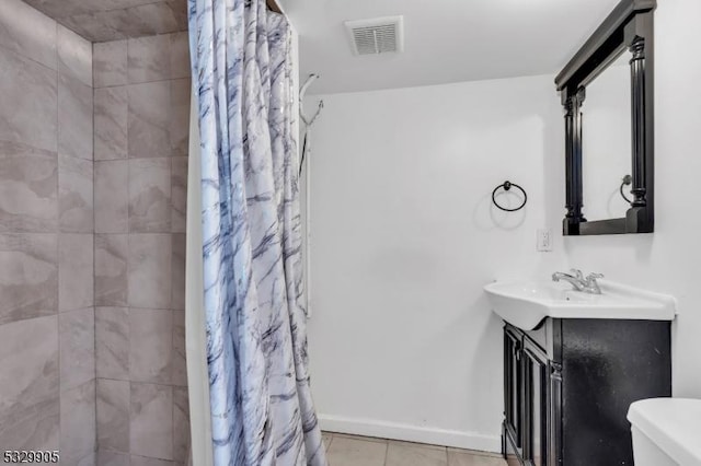 bathroom featuring vanity, walk in shower, tile patterned floors, and toilet