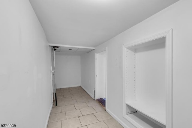 spacious closet featuring light tile patterned floors