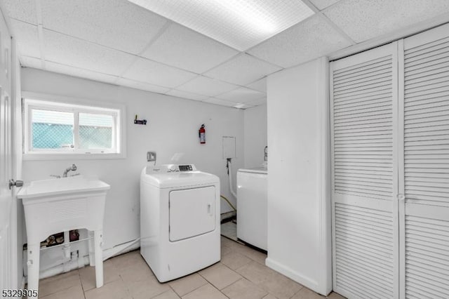 laundry room featuring light tile patterned floors and washer and clothes dryer