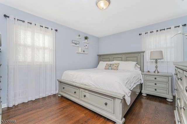 bedroom with dark hardwood / wood-style floors