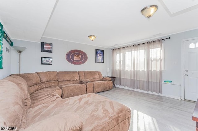 living room featuring crown molding and light wood-type flooring