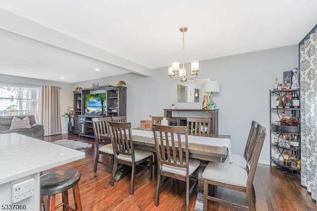 dining space with a notable chandelier, beam ceiling, and dark wood-type flooring