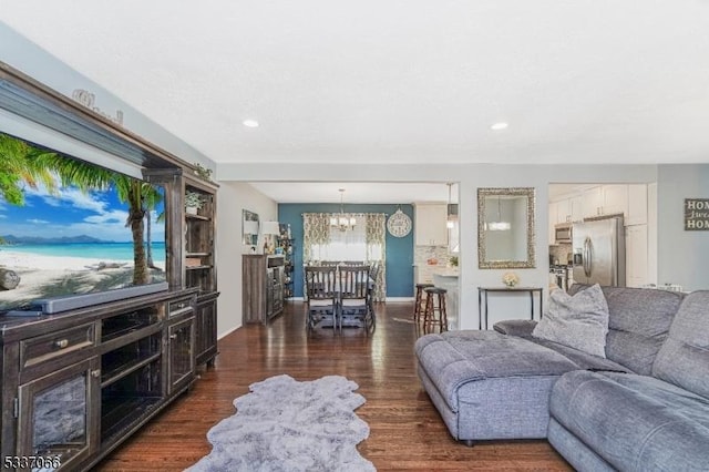 living room with dark hardwood / wood-style flooring and a chandelier