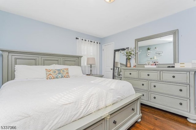 bedroom with dark hardwood / wood-style flooring