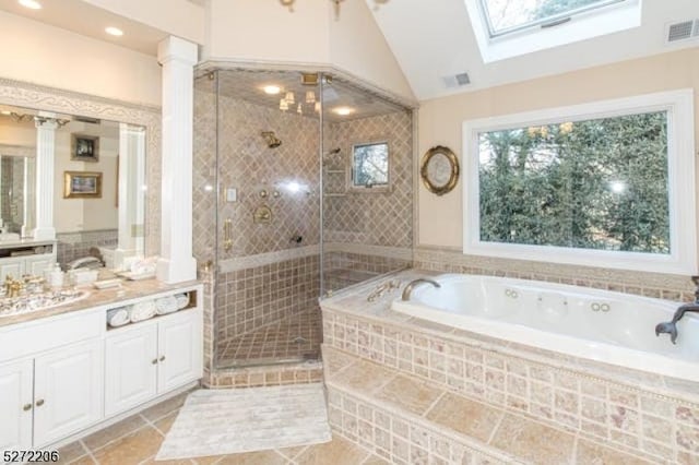 bathroom with vanity, tile patterned floors, lofted ceiling with skylight, and shower with separate bathtub