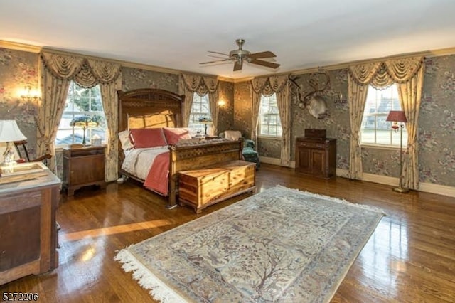 bedroom with ceiling fan, ornamental molding, and dark hardwood / wood-style floors