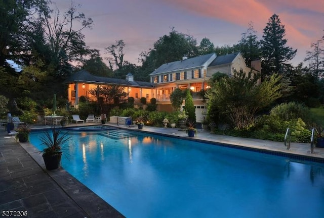 view of pool at dusk