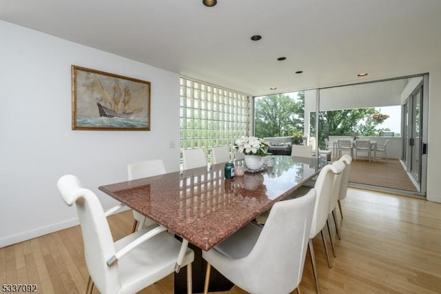 dining space with light hardwood / wood-style flooring