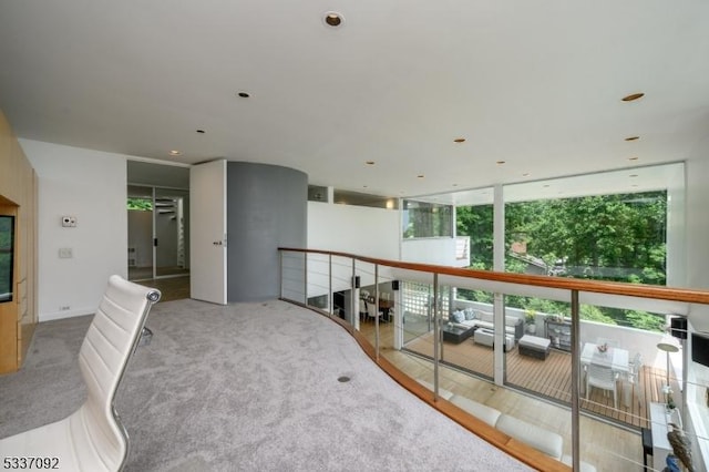 corridor with floor to ceiling windows and carpet floors