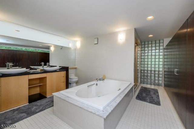 full bathroom featuring independent shower and bath, vanity, tile patterned floors, and toilet