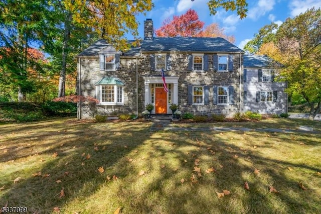 colonial home with a front lawn