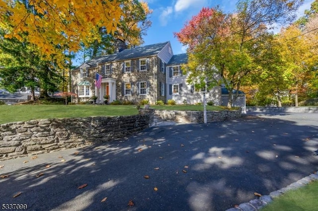 colonial-style house with a front yard