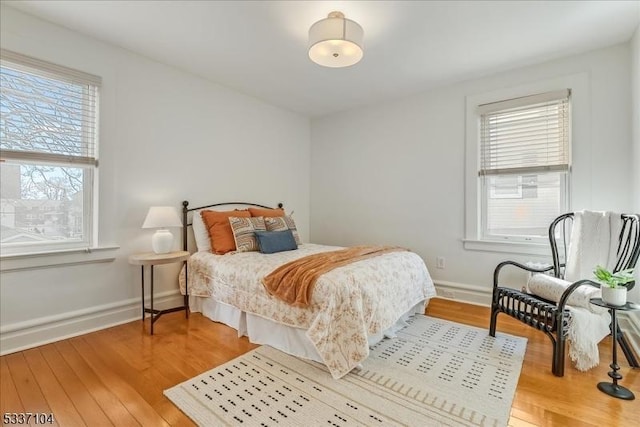 bedroom featuring baseboards and wood finished floors