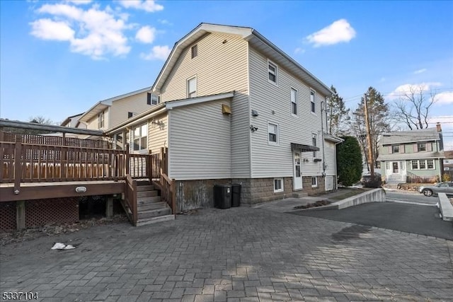 view of side of property with a wooden deck