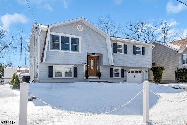 split foyer home with a garage and a gambrel roof